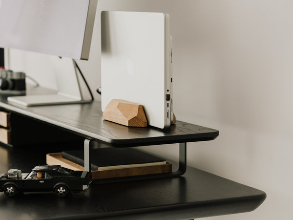 side view of black wooden desk shelf with additional accessories | -